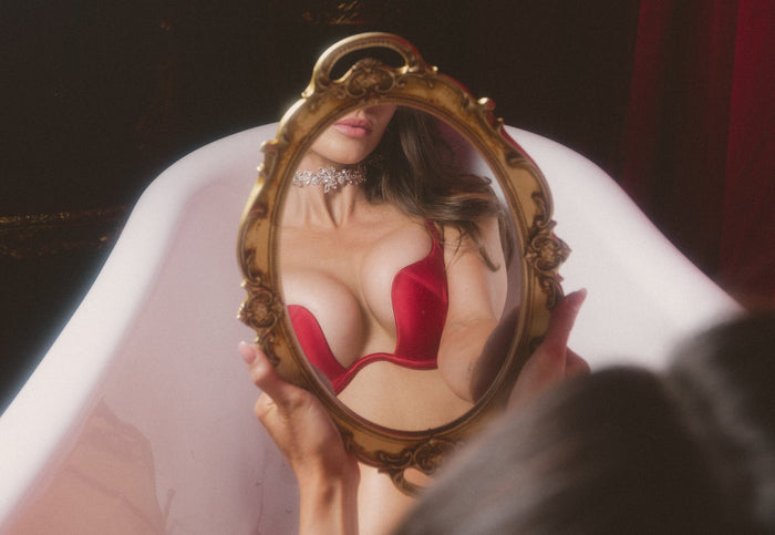 Model with platinum hair wearing the Frederick's rising star plunge push up bra  in sirocco