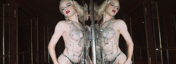 Two women, one in all-black and one in all-white sexy Halloween featuring Frederick's of Hollywood lingerie. 