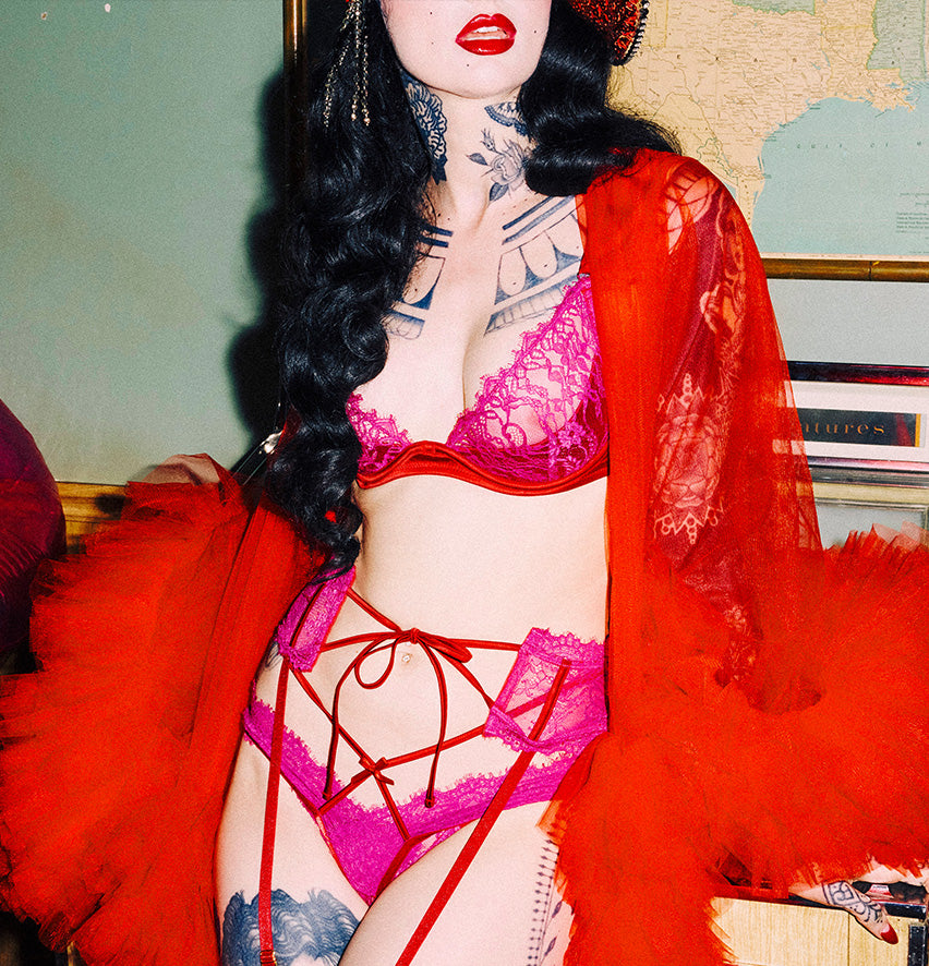 woman wearing dark pink lingerie and red robe
