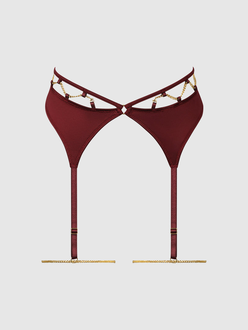 The Emery Liquid Satin & Chain Thigh Garter Belt by Frederick’s of Hollywood, featuring a burgundy satin finish with gold chain accents and adjustable straps, is displayed on a plain white background.