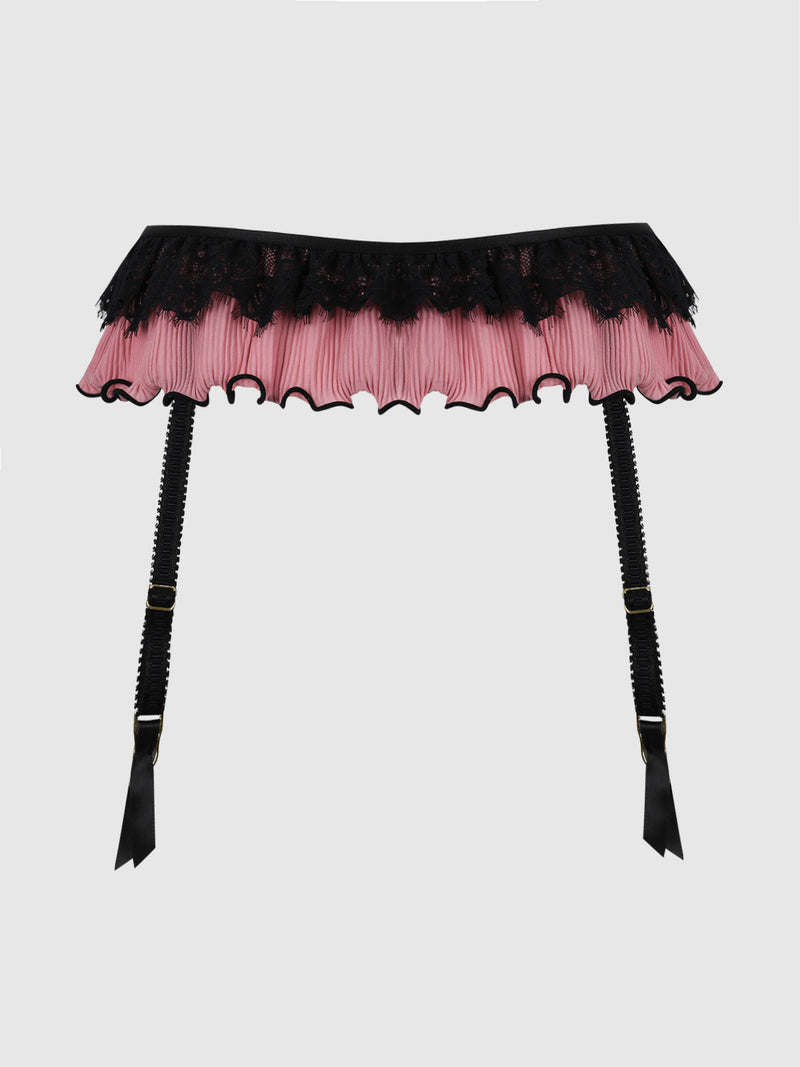 The Esme Lace & Pleated Chiffon Garter Belt by Frederick’s of Hollywood features pink pleated chiffon with black lace trim and two adjustable black straps finished with ribbon ends, showcased against a plain light background.