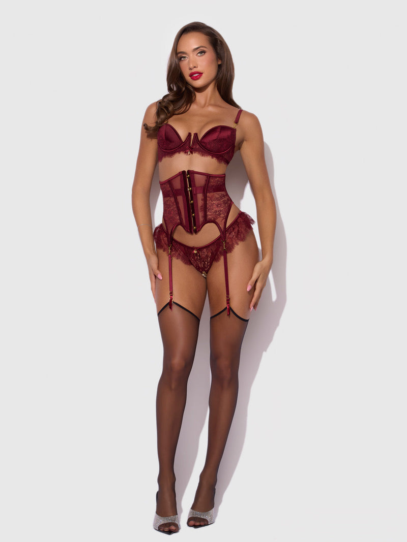 A model wearing a burgundy Lilith Lace & Mesh Waist Garter with matching lingerie and black stockings.
