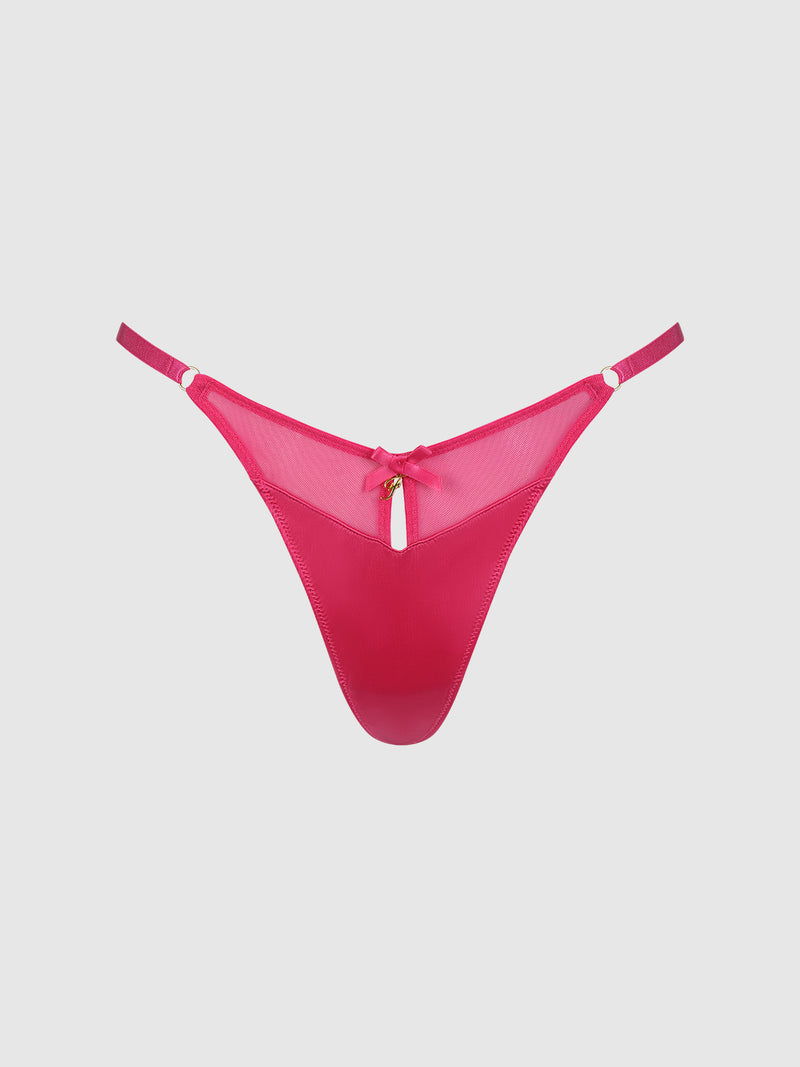 The Scarlett Mesh G-String by Frederick's of Hollywood is a bright pink thong with bold mesh panels, thin adjustable side straps, gold ring accents, and a small bow with a keyhole cutout at the front, shown on a plain light background.