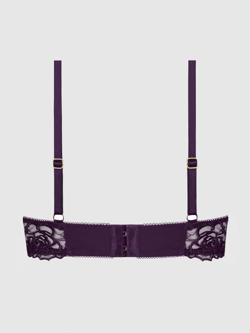 The Melrose Strappy Cutout Bra by Frederick's of Hollywood features a back view in purple with adjustable straps, mesh panels, and floral lace embroidery on both sides, set against a plain light gray background.