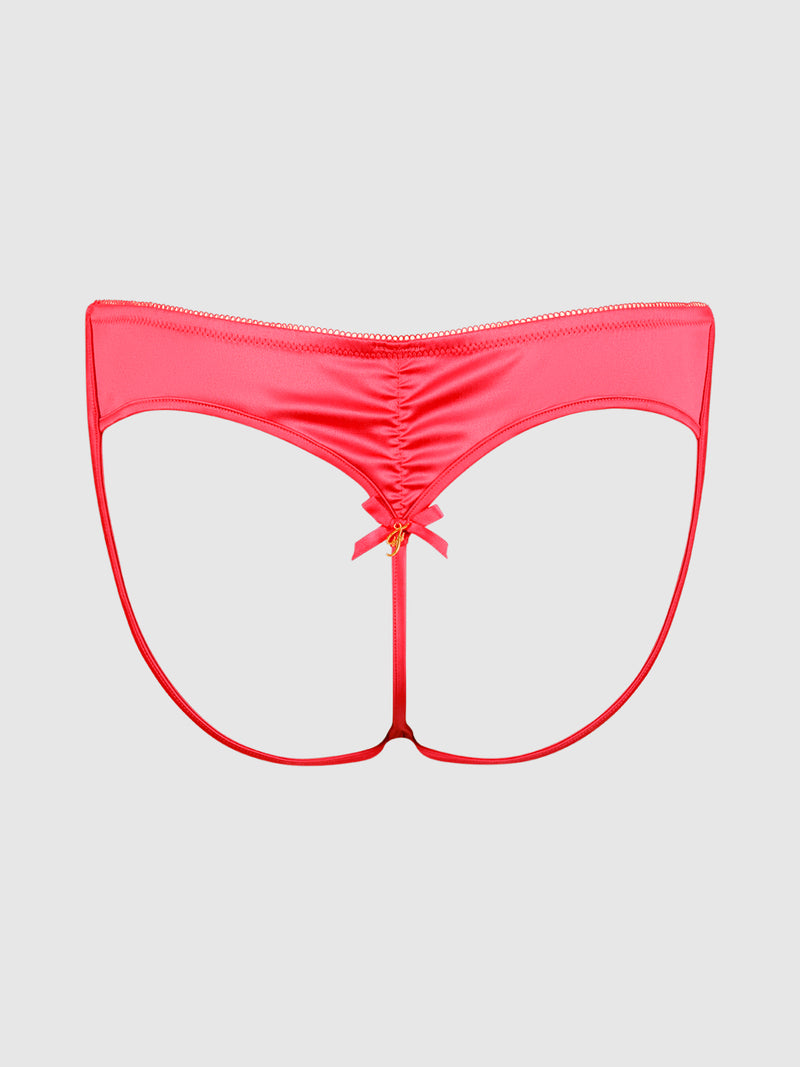 The Petra Heart Open Back Bikini by Frederick’s of Hollywood is a bright pink thong featuring an open back, a ruched center seam, and a small satin bow at the center, displayed on a plain gray background.