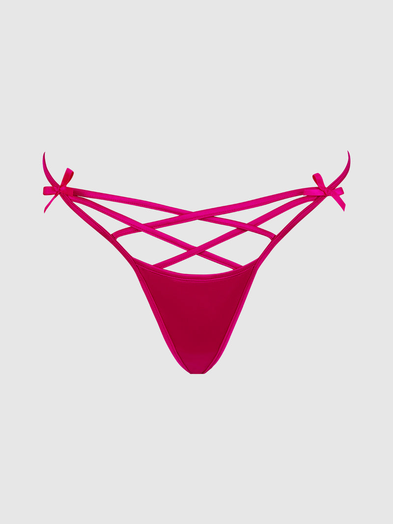 The Frederick's of Hollywood Petra Heart Open Back Bikini features bright pink crisscross straps and small side bows, shown against a plain light gray background.