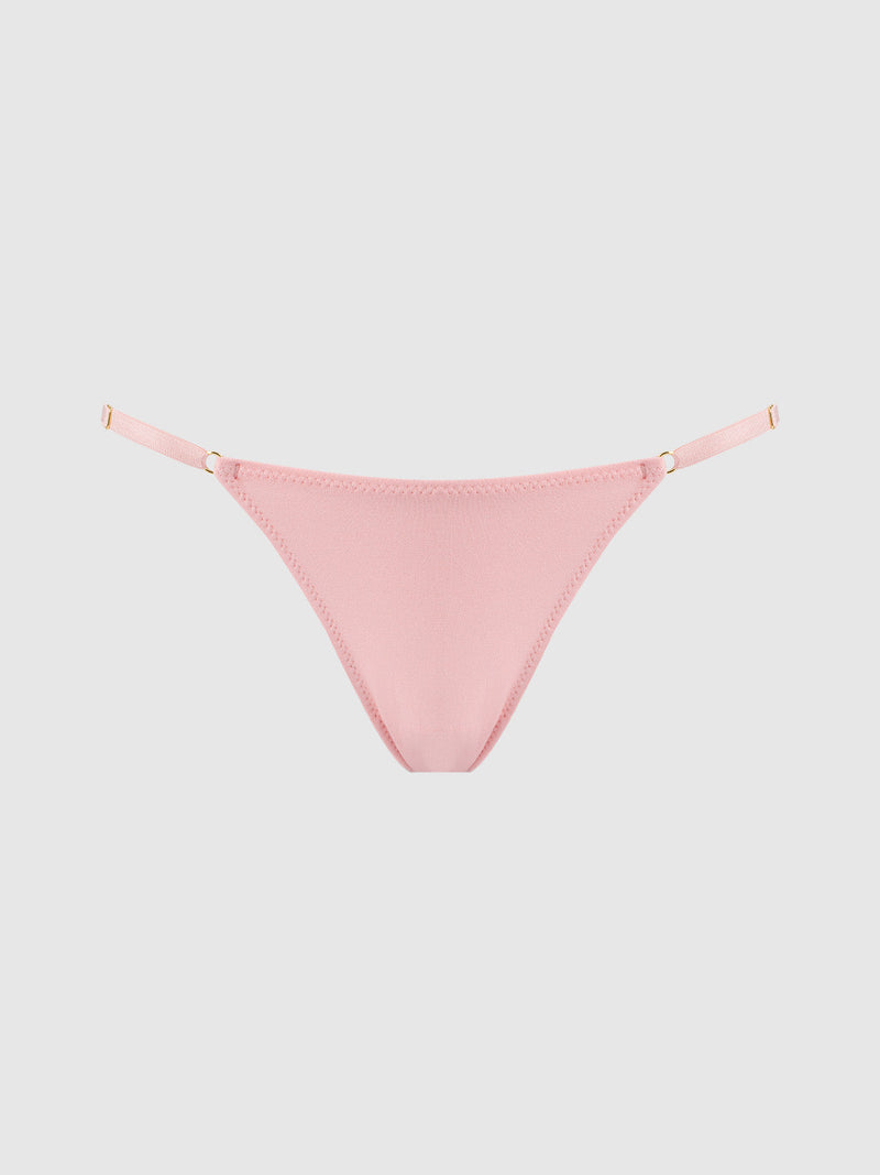 The Bailey Stretch Cotton Bikini by Frederick's of Hollywood is a light pink, curve-hugging bottom with thin adjustable side straps, shown on a plain light gray background.