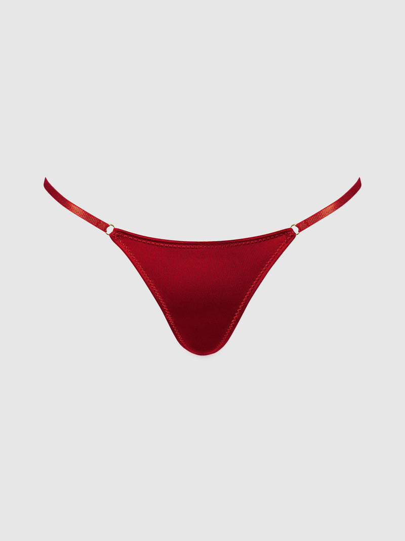 The Frederick’s of Hollywood Rising Star Liquid Satin Mini G-String, in vibrant red with thin side straps, is showcased against a simple light gray background.
