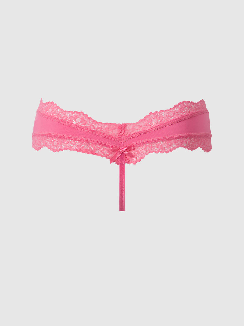 The Jenna Micro G-String from Frederick's of Hollywood is a pink, silky-soft lace underwear featuring a center bow and delicate lace trim, shown on a plain light background.