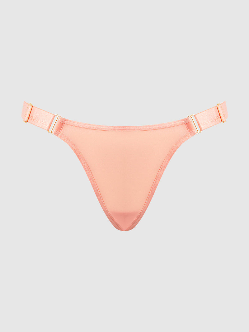 The Pia Elastic Side Mesh Thong by Frederick's of Hollywood features peach mesh, elastic adjustable straps, and gold hardware—an ideal blend of comfort and sexy style, showcased on a light gray background.
