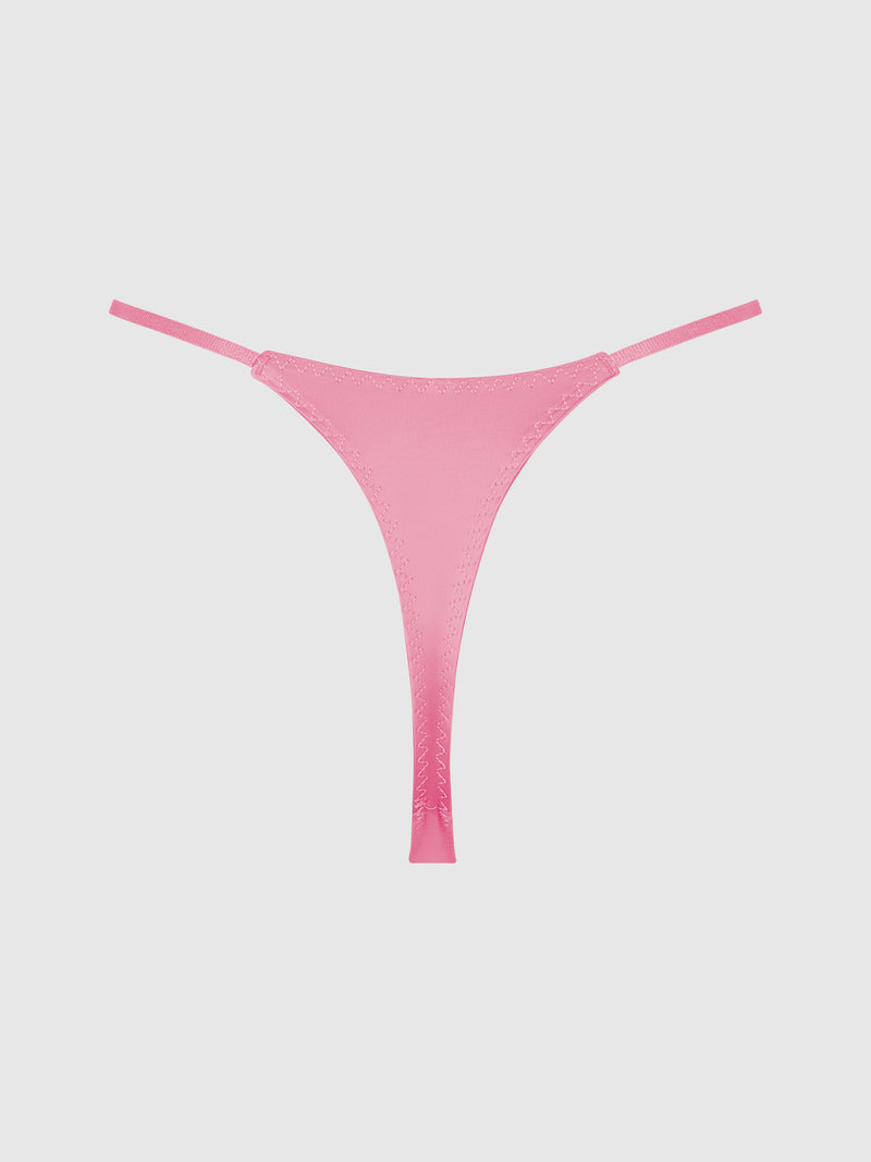 The Rising Star Liquid Satin Thong by Frederick’s of Hollywood is shown in pink with thin side straps against a plain white background.