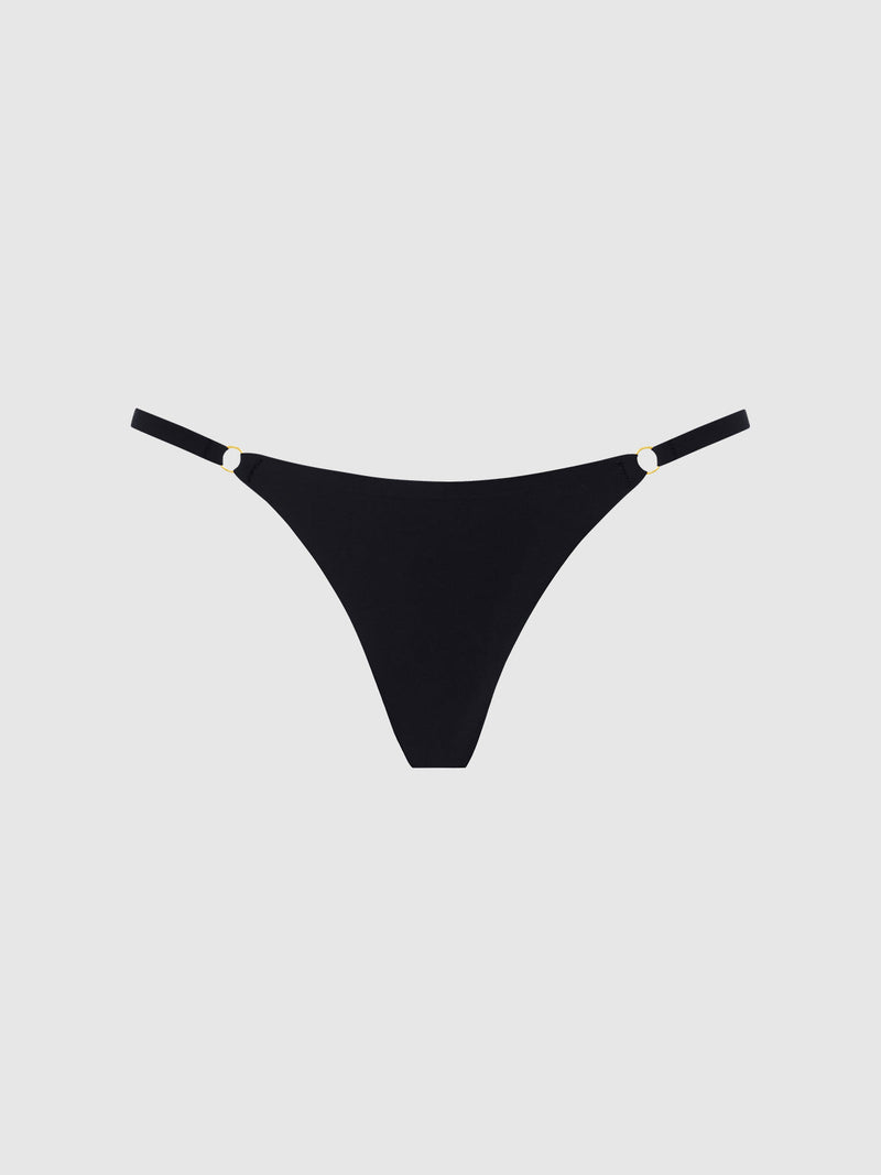 The Frederick's of Hollywood No Show Mid Rise Thong in black features thin side straps with small gold ring accents and a thong cut for a seamless fit, shown against a plain light gray background.