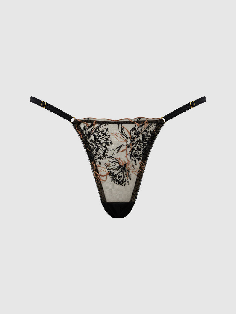 The Delfina Embroidered Side Slider Thong by Frederick's of Hollywood features black adjustable straps and a sheer black and beige floral embroidered mesh front, shown against a plain light background.