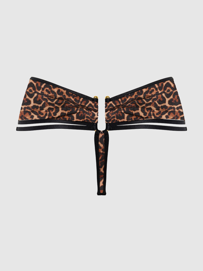 The Raven Crotchless & Strappy U-Hook Panty by Frederick’s of Hollywood is styled here with a leopard print bandeau bikini top featuring a keyhole front cutout and a central black strap, set against a plain light background.