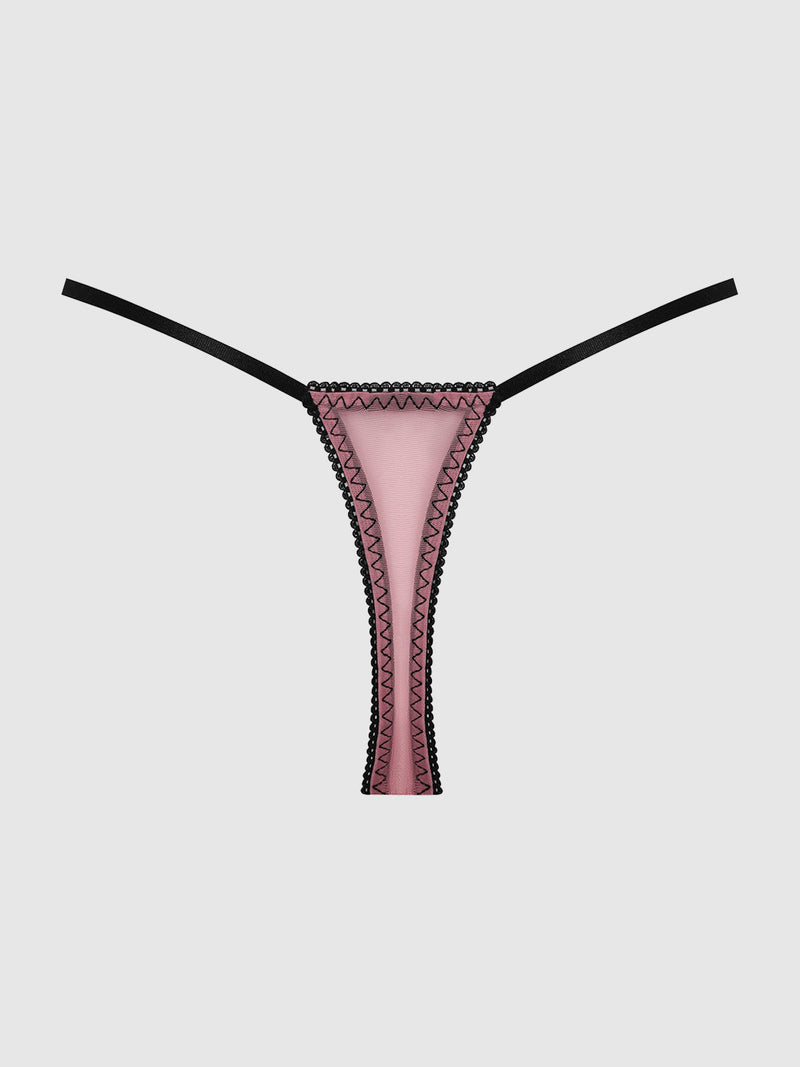 The Esme Pleated Chiffon & Lace Thong by Frederick’s of Hollywood features pink mesh with black zigzag stitching along the edges and thin black straps, displayed against a plain white background.