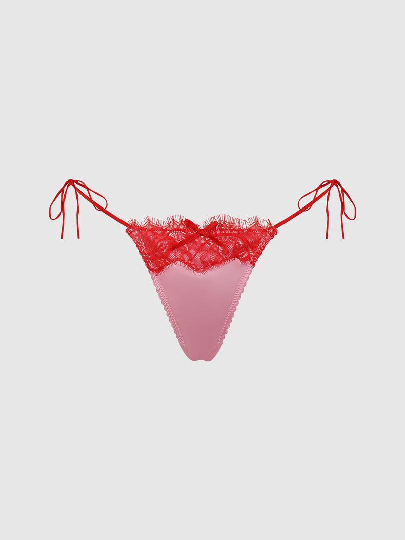 The Rising Star Liquid Satin & Lace Tie Side Thong by Frederick's of Hollywood features pink satin, red lace trim, and side ties, displayed on a plain light background.