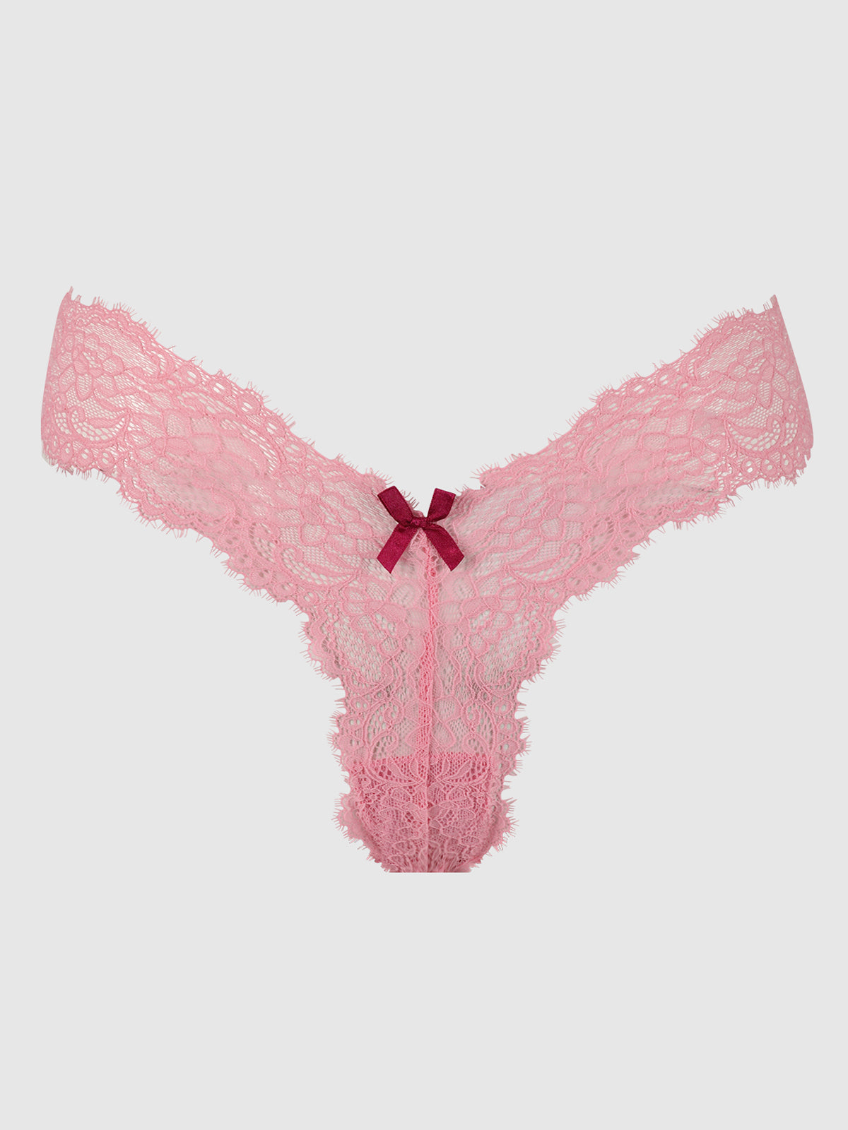 The Lulu Lace V-Thong by Frederick's of Hollywood features pink lace with scalloped edges, minimal back coverage, and a dark pink bow at the center front, shown against a plain light gray background.