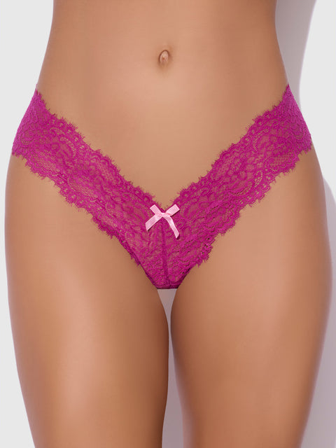 Close-up of a person wearing the Lulu Lace V-Thong by Frederick's of Hollywood in magenta, featuring a small pink bow at the front center. The stretch lace design offers minimal back coverage against a plain background.