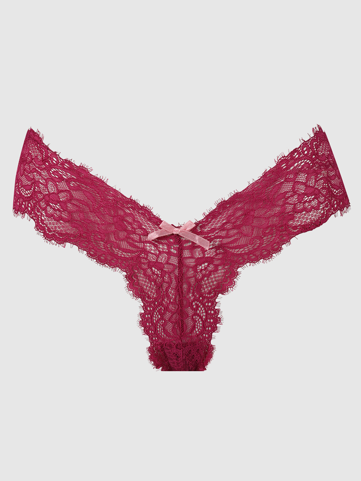 The Lulu Lace V-Thong by Frederick's of Hollywood features burgundy stretch lace with scalloped edges and a pink ribbon bow at the front, offering minimal back coverage. Displayed on a light gray background.