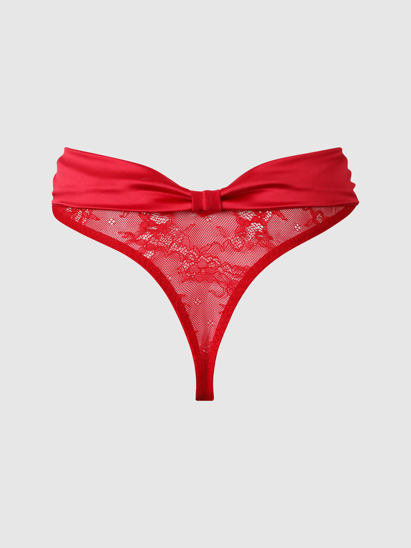 The Marilyn Monroe Lace & Satin Thong by Frederick’s of Hollywood features a red floral lace mesh front panel and a solid red waistband, showcased against a plain light gray background.