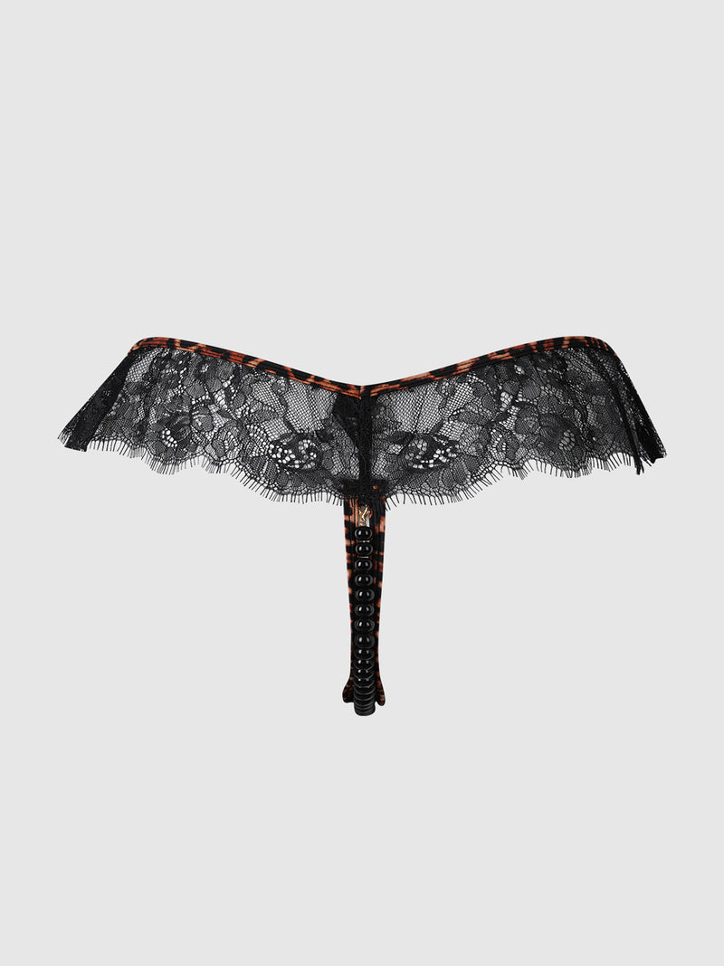 The Raven Leopard And Lace Crotchless Pearl Thong by Frederick's of Hollywood is showcased on a plain light gray background, featuring delicate black floral lace with leopard-print trim and a strappy waistband detail.
