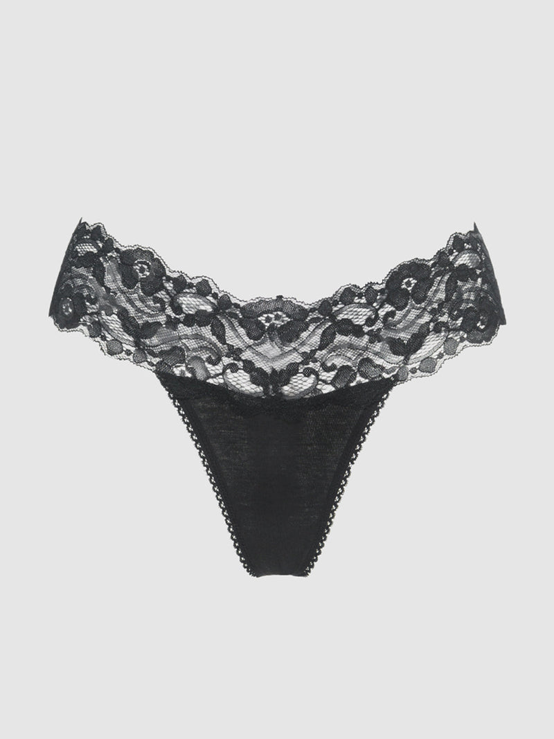 The Bridget Stretch Cotton & Lace Thong by Frederick's of Hollywood features black floral lace with a scalloped waistband and solid cotton front—a chic, elegant addition to your intimate collection.