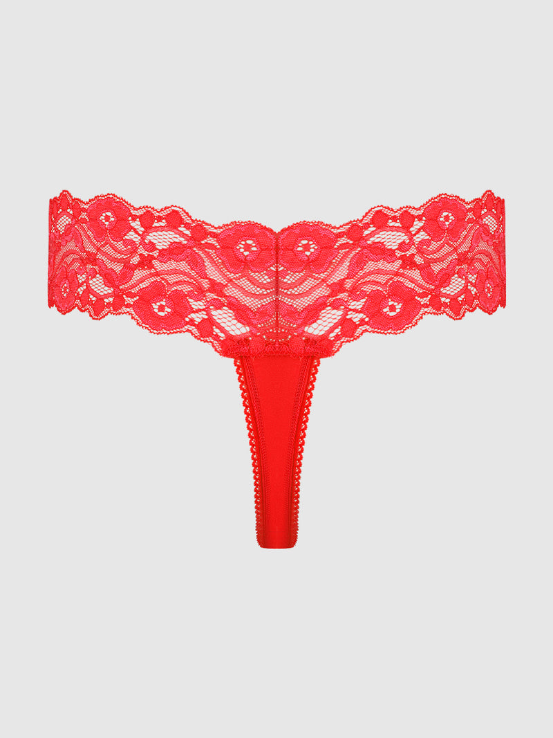 The Bridget Stretch Cotton & Lace Thong by Frederick's of Hollywood features a wide floral lace waistband and minimal coverage, displayed on a plain light gray background.