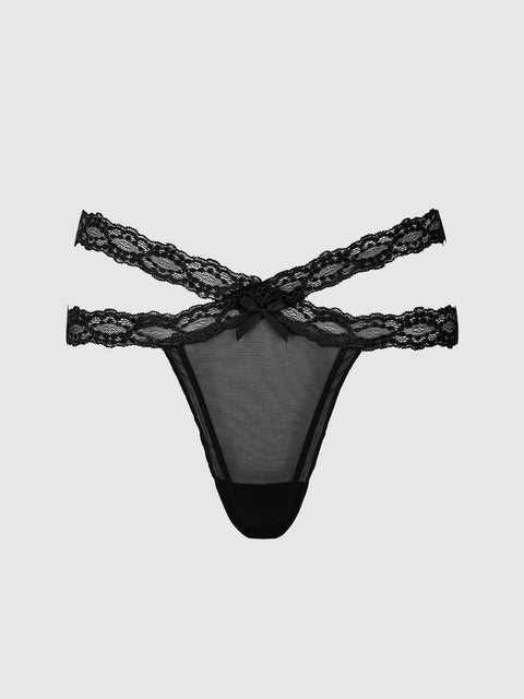 The Stella Mesh & Lace Double Band Thong by Frederick’s of Hollywood features two crisscrossed lace straps and a delicate front bow, shown on a plain light gray background.