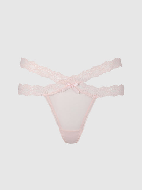 The Stella Mesh & Lace Double Band Thong by Frederick’s of Hollywood features light pink lace, double waistband straps, and a small bow detail at the front, shown against a plain white background.
