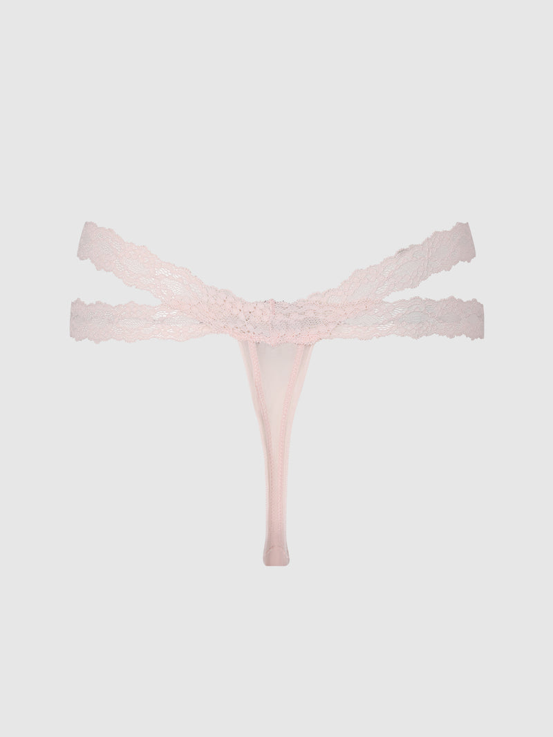 The Stella Mesh & Lace Double Band Thong by Frederick’s of Hollywood is shown in light pink, featuring delicate lace and a double waistband, against a plain light gray background.
