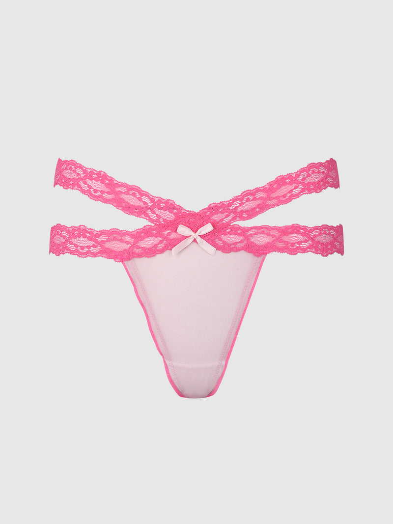 The Stella Mesh & Lace Double Band Thong by Frederick’s of Hollywood features pink lace, a double waistband design, and a small bow at the front, displayed on a plain white background.