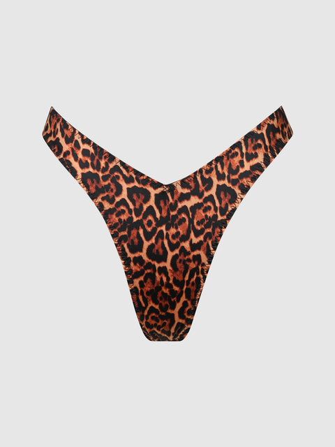 The Rising Star Liquid Satin Tanga by Frederick's of Hollywood features a V-shaped front and bold leopard print in brown, orange, and black, shown against a plain white background.