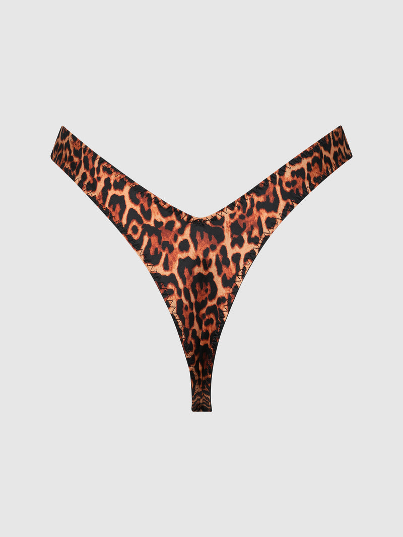 The Frederick's of Hollywood Rising Star Liquid Satin Tanga features a bold leopard print, showcased against a plain white background.