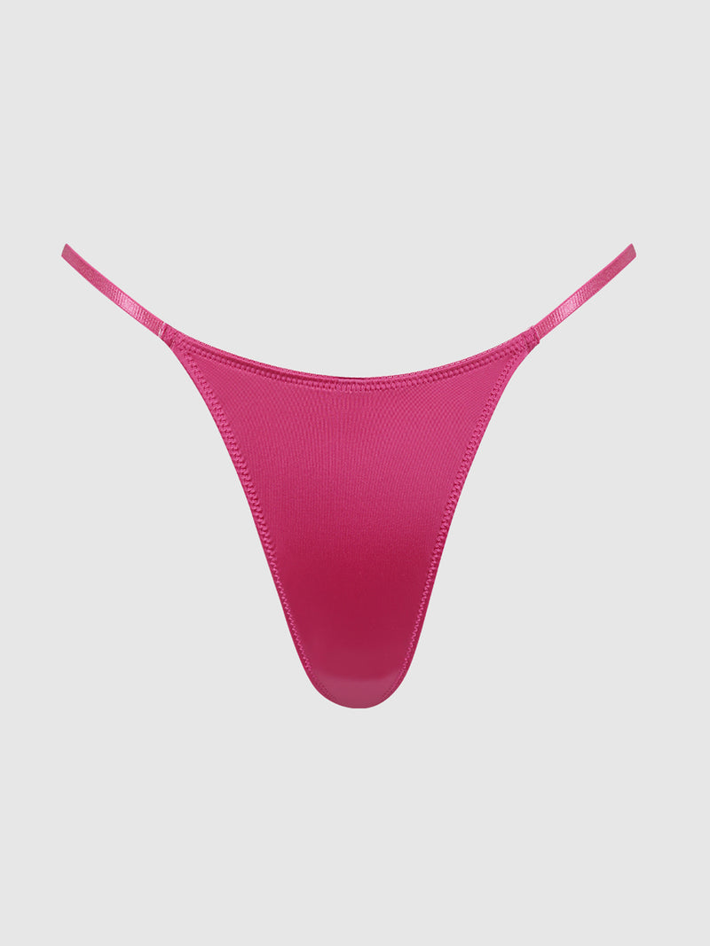 The Nadya Liquid Satin & Rope Thong by Frederick’s of Hollywood, featuring a vibrant pink hue and delicate rope side straps, is displayed against a plain, light gray background.