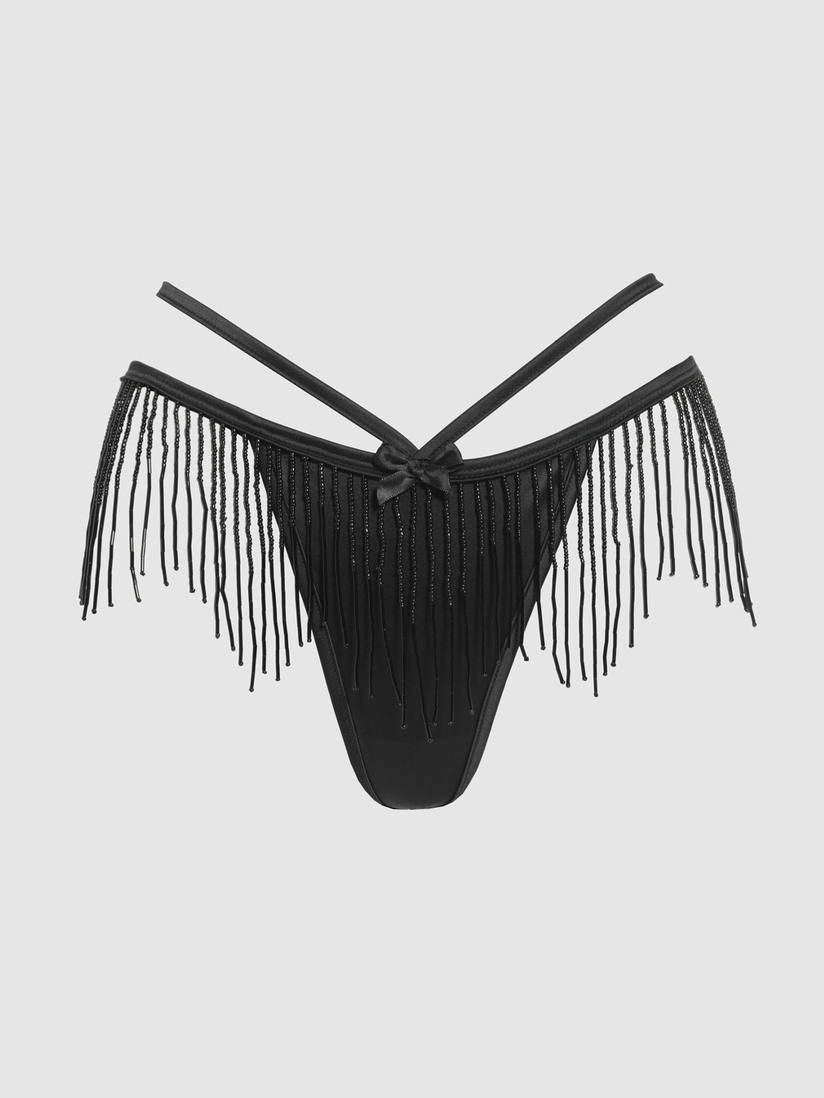 The Lune Beaded & Strappy Thong by Frederick's of Hollywood features black satin, beaded details, thin crisscross straps, fringe accents along the hips, and a front bow, shown on a plain light background.