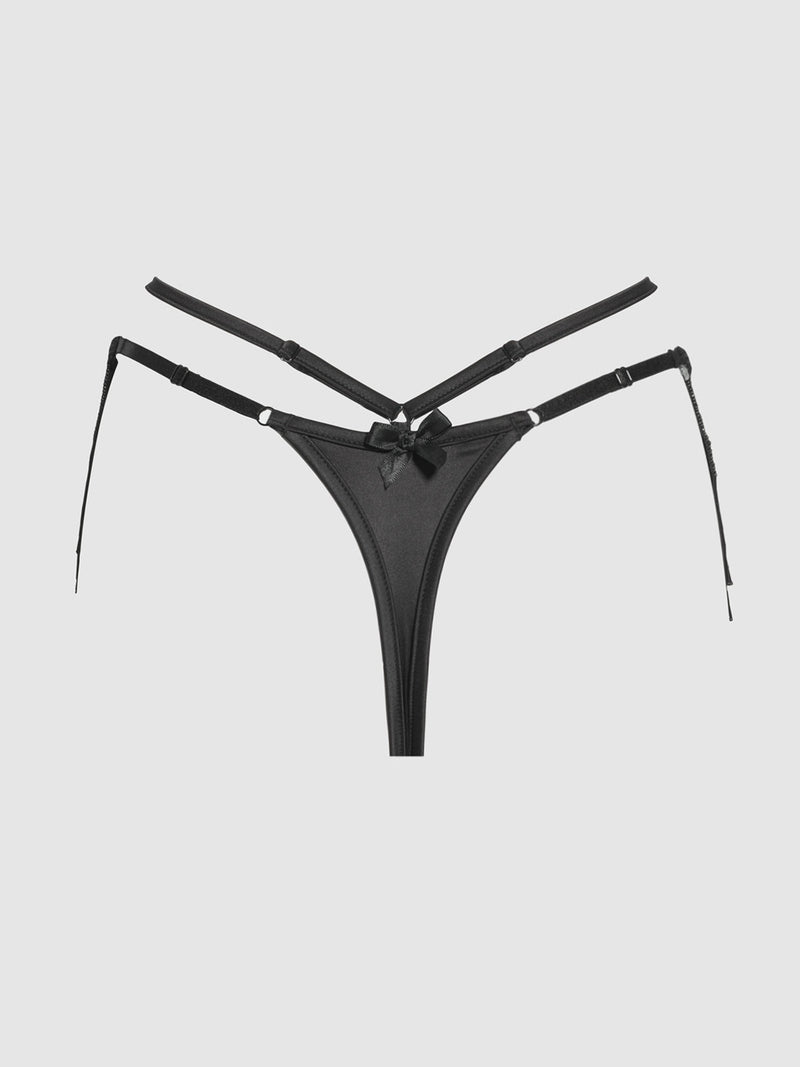 The Lune Beaded & Strappy Thong by Frederick's of Hollywood features adjustable straps, a central mesh panel, and a decorative front bow, shown here in black on a plain light background.