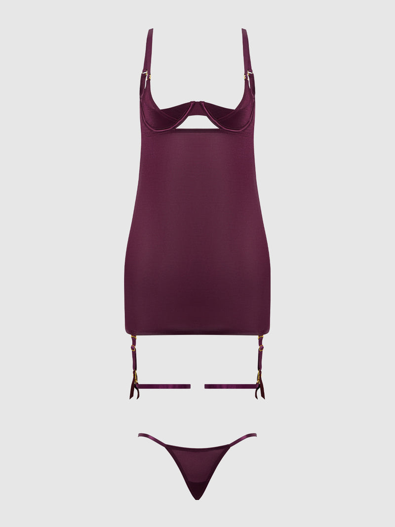The Pia Shine Mesh O-Ring Thigh Garter Chemise Set by Frederick's of Hollywood features a fitted chemise with underwire cups, removable garters, and matching thong in burgundy, exuding vintage glam on a plain light gray background.