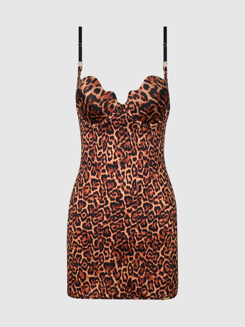 The Director's Cut Lightly Lined Chemise Dress by Frederick's of Hollywood is a sleeveless, bodycon mini dress with a bold leopard print and black adjustable straps, shown against a plain white background.