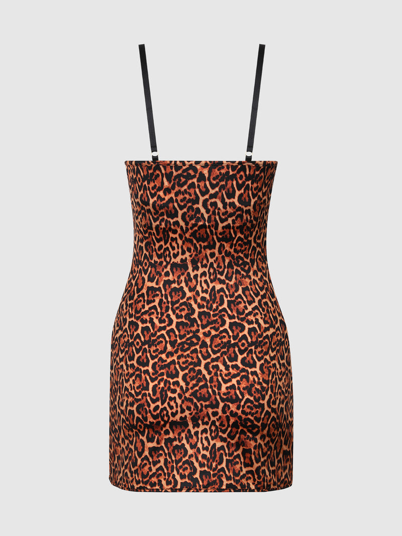 The Frederick's of Hollywood Director's Cut Lightly Lined Chemise Dress is a sleeveless, bodycon mini dress featuring thin black straps and a bold orange and black leopard print, shown on a plain white background.