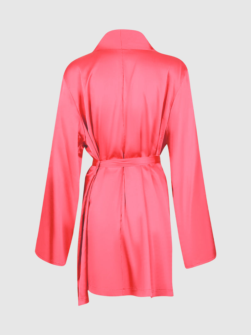 The Petra Satin Short Robe by Frederick’s of Hollywood is shown from the back in a vibrant pink color, showcasing its long sleeves, belted waist, and smooth, lustrous finish against a plain white background.