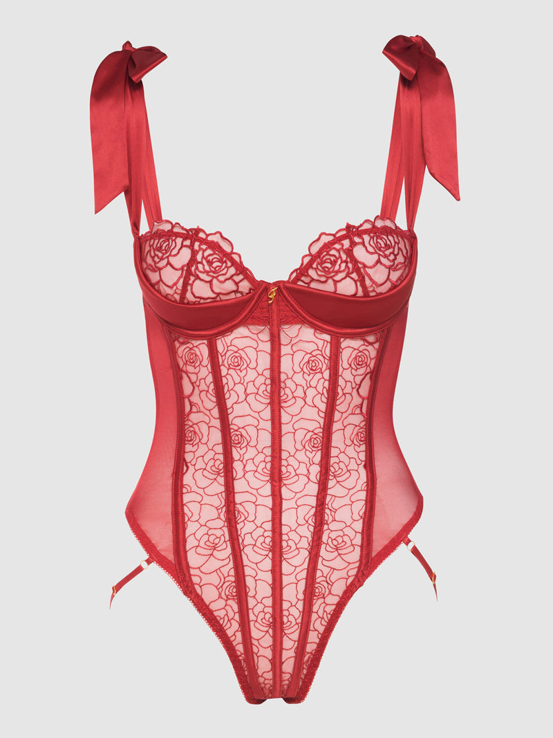 The Melrose Embroidered Teddy by Frederick's of Hollywood features red floral lace, sheer mesh panels, underwire cups, and satin ribbon straps tied in bows at the shoulders.