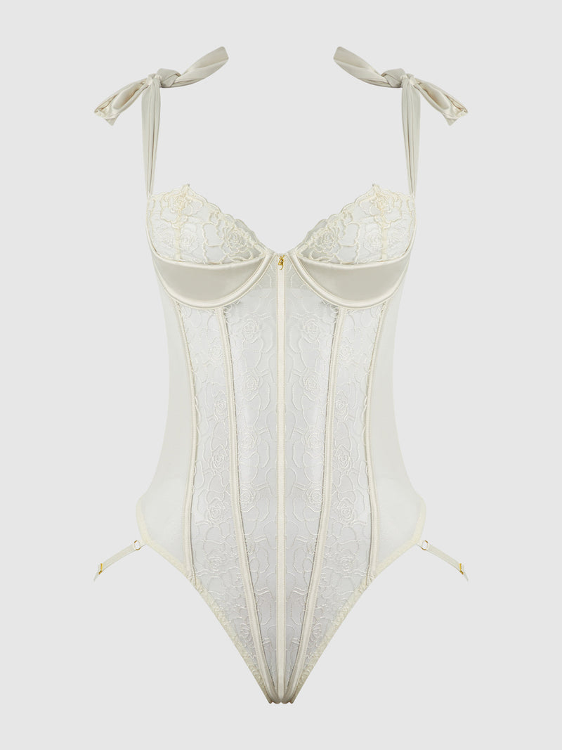 The Melrose Embroidered Teddy by Frederick's of Hollywood features underwire support, adjustable bow-tied straps, sheer lace panels, and high-cut legs, shown against a plain white background.