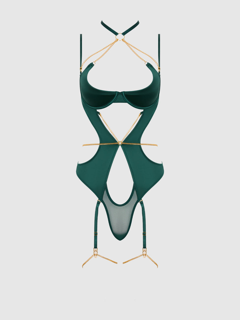 The Emery Liquid Satin & Chain Halter Teddy by Frederick's of Hollywood features dark green satin, gold chain detailing, sheer mesh panels, and bold cut-outs, shown against a plain light background.