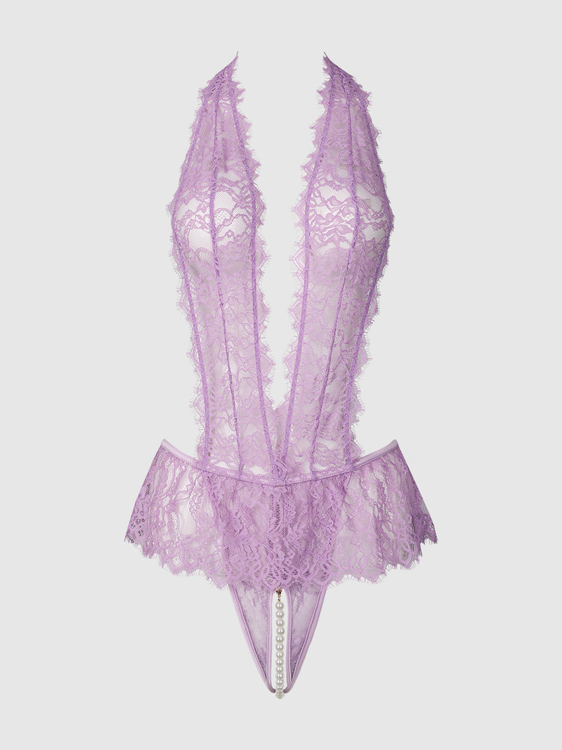The Rosalind Lace & Pearl Crotchless Teddy by Frederick’s of Hollywood features lavender lace, a deep V neckline, halter straps, peplum detail at the hips, and pearl accents along the crotch.