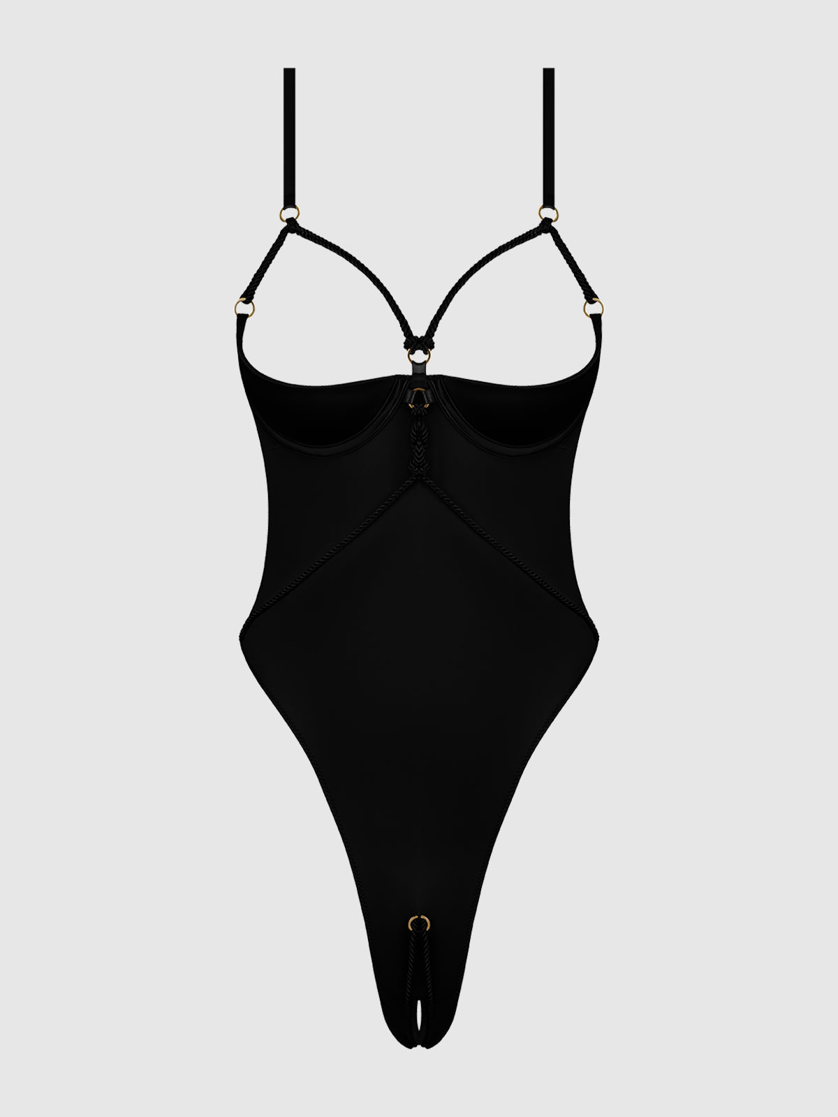 The Nadya Liquid Satin & Rope Crotchless Teddy by Frederick's of Hollywood is a black strappy bodysuit with thin adjustable straps, gold ring accents, underwire cups, and high-cut legs, shown on a plain light gray background.