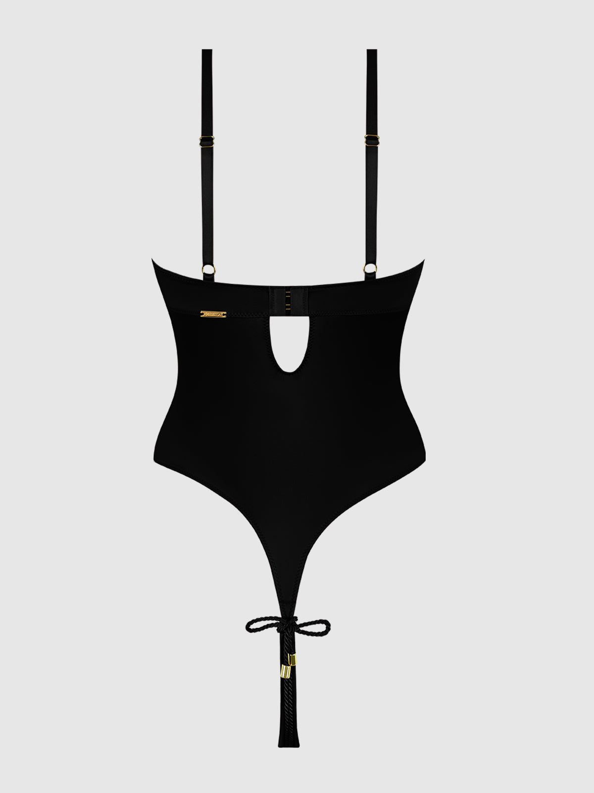 The Nadya Liquid Satin & Rope Crotchless Teddy by Frederick's of Hollywood features adjustable straps, a front keyhole cutout, gold hardware, playful ropes, and a bow detail, shown on a light gray background.