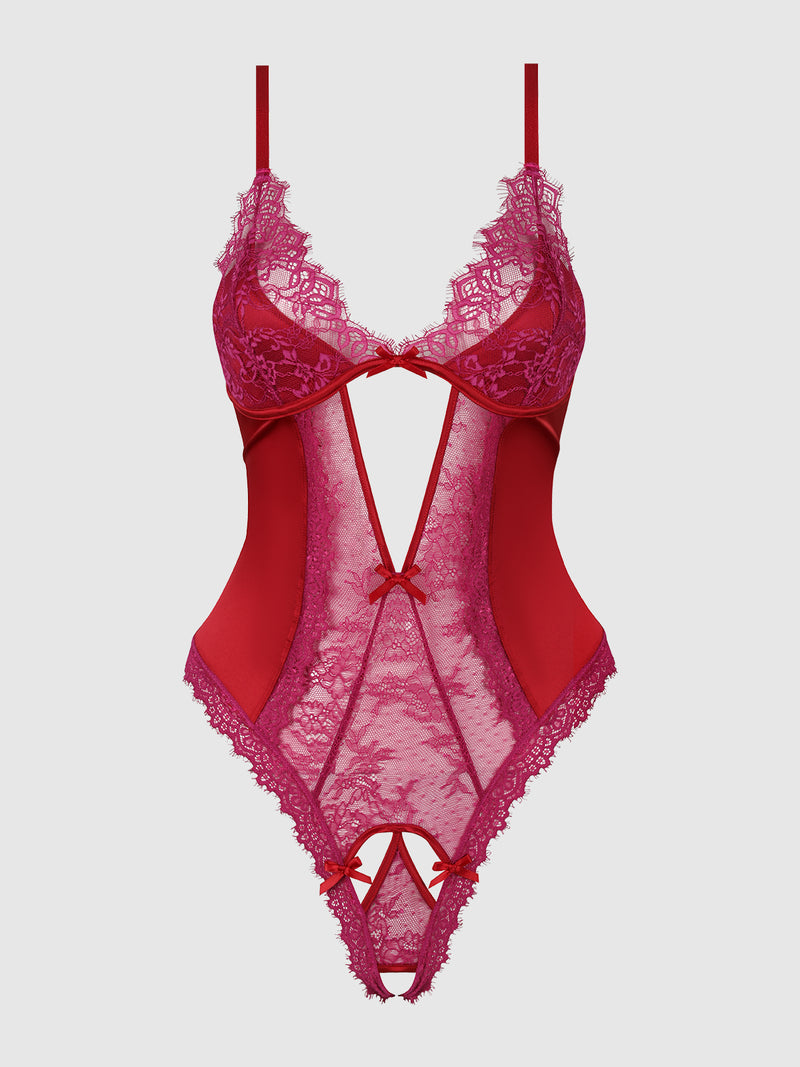 Introducing the Rosalind Satin & Lace Crotchless Teddy from Frederick's of Hollywood—a seductive red teddy crafted with sheer floral lace panels, thin straps, decorative bows, and intricate lace detailing. This alluring design features cut-out sections at the front for an irresistibly provocative lingerie look.