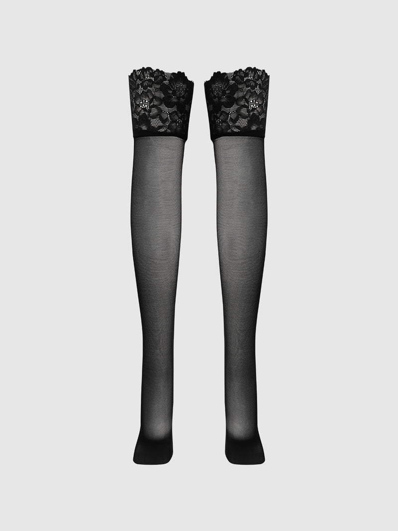 The Frederick's of Hollywood Glossy Cross Dye Lace Top Sheer Stay Up Thigh Highs are shown against a plain light gray background, featuring elegant lace tops and a sheer, glossy finish.