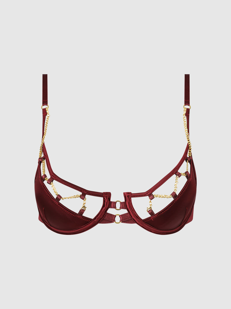 The Emery Liquid Satin & Chain Bra by Frederick’s of Hollywood features a rich burgundy hue, gold chain accents, and adjustable straps, displayed against a plain white background.
