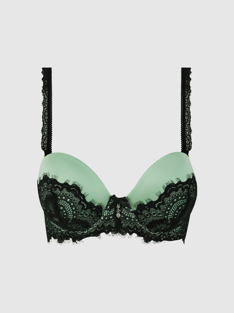 The Lexi Lace Strapless Push Up Bra by Frederick's of Hollywood features padded cups with a black lace overlay and decorative black lace straps, shown in light green on a plain light gray background.